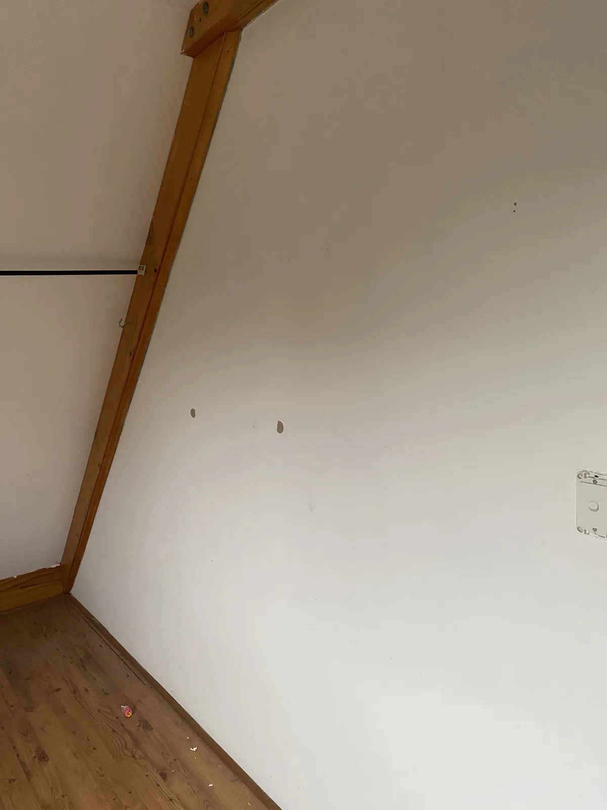 Cream raked-ceiling room after