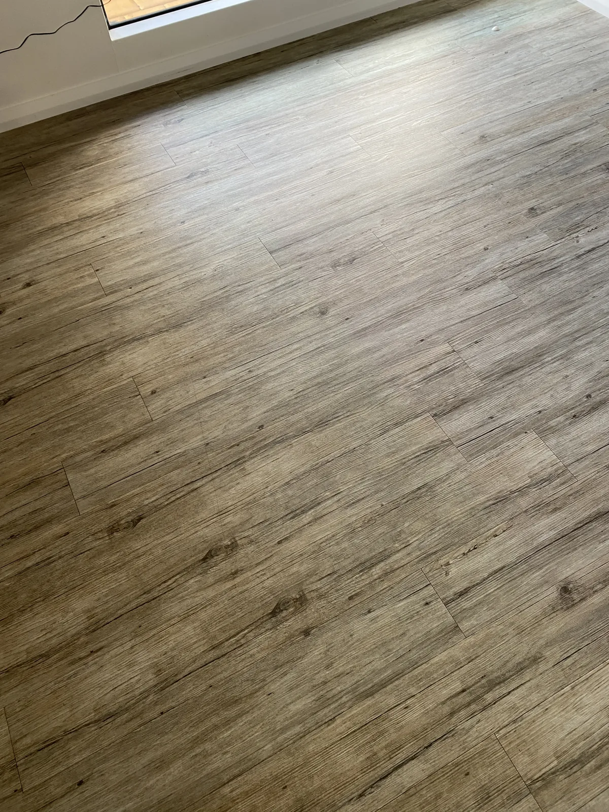 Dull dusty vinyl plank floor before cleaning